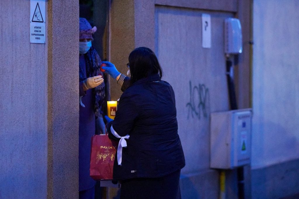 Volunteers share the Holy Light on the streets of Bucharest PHOTO: Raed Krishan