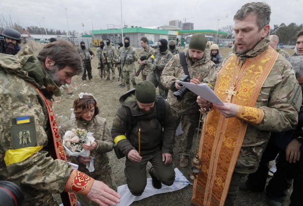 Nuntă pe front. În haine de camuflaj, cu alai înarmat cu flori și puști, doi militari ucraineni s-au căsătorit