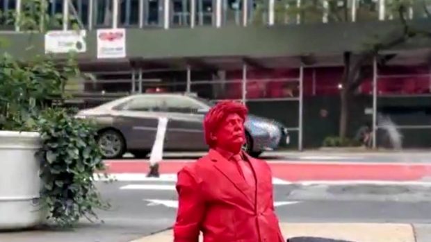 Donald Trump în varianta roșu aprins: imagine cu sculptura care iese dintr-o gură de canal